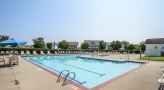 community pool surrounded by seating and concrete