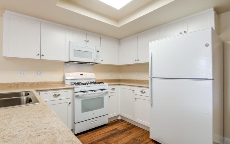 a kitchen with white cabinets
