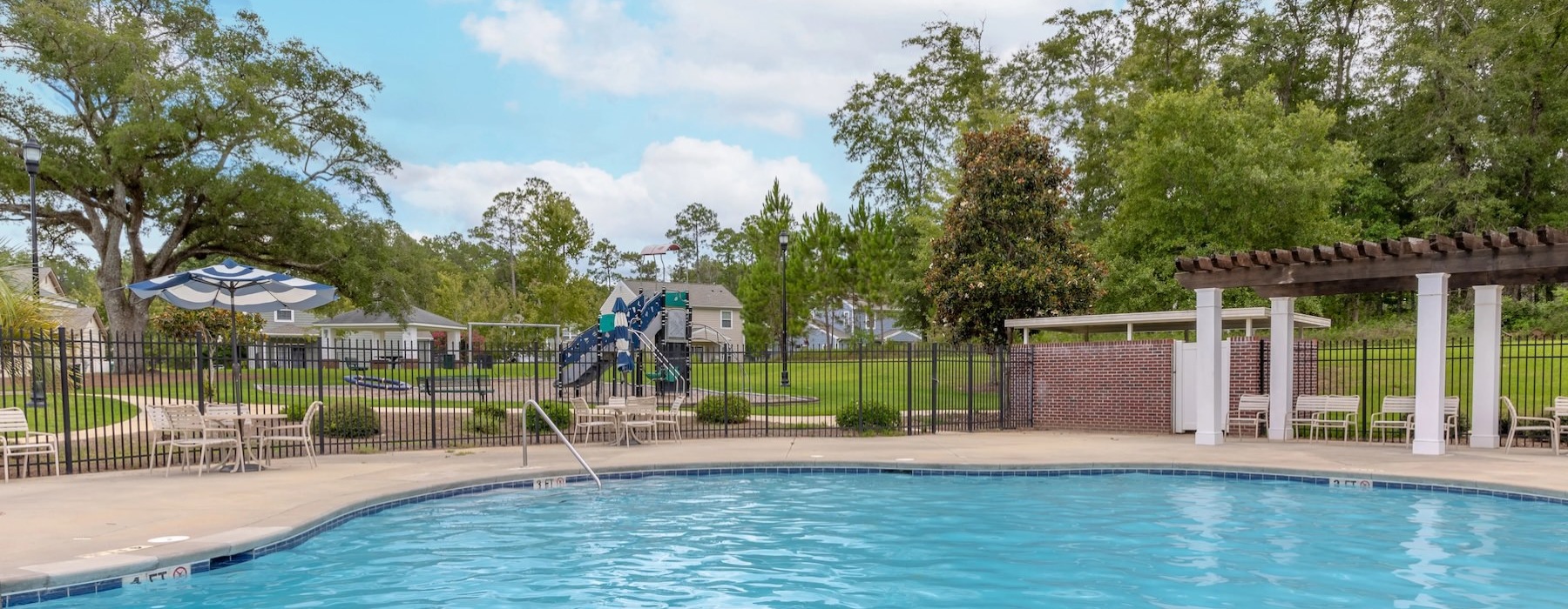 Resort-style swimming pool with lounge seating