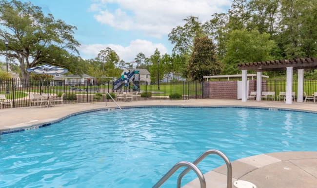 Resort-style swimming pool with lounge seating