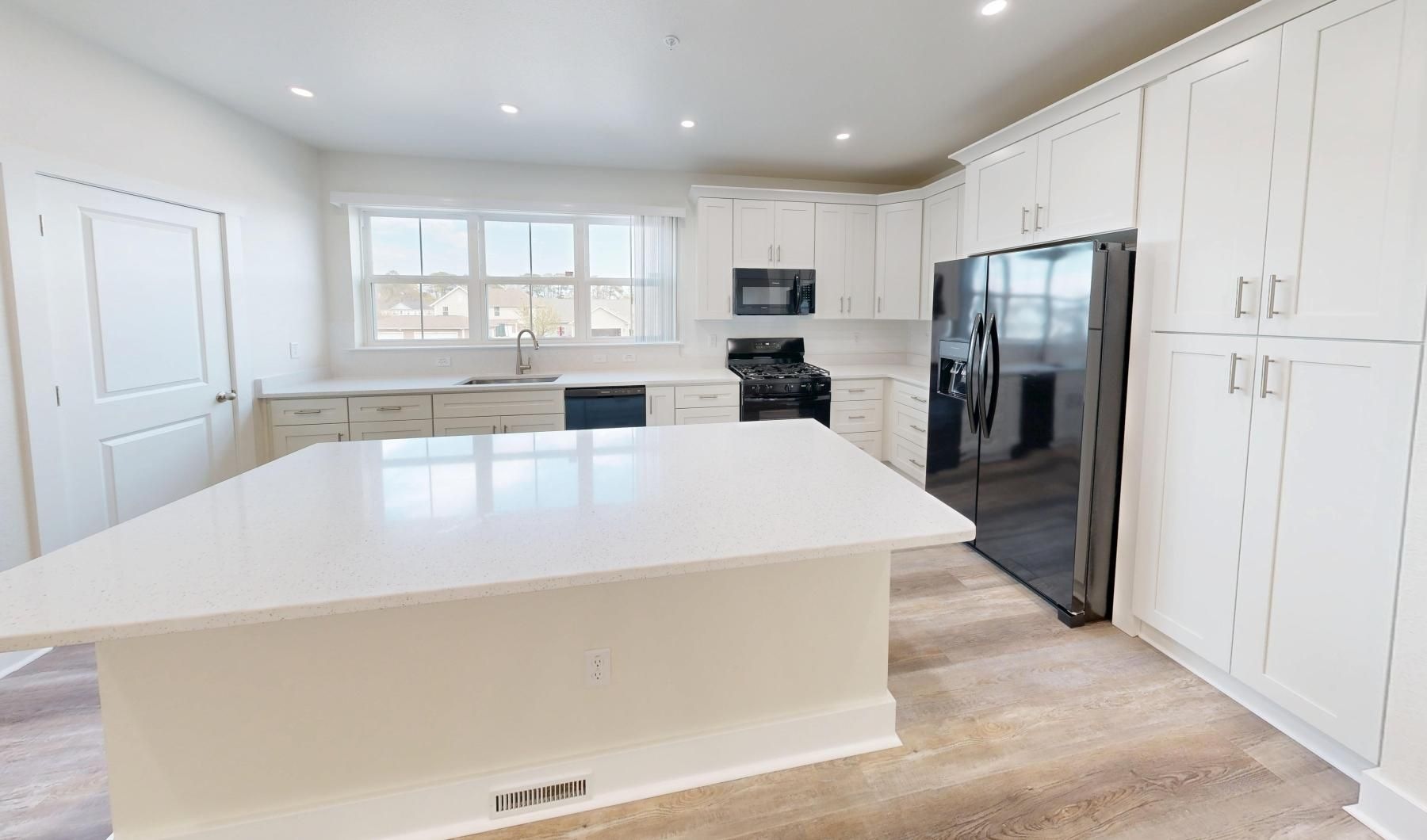 a kitchen with white cabinets