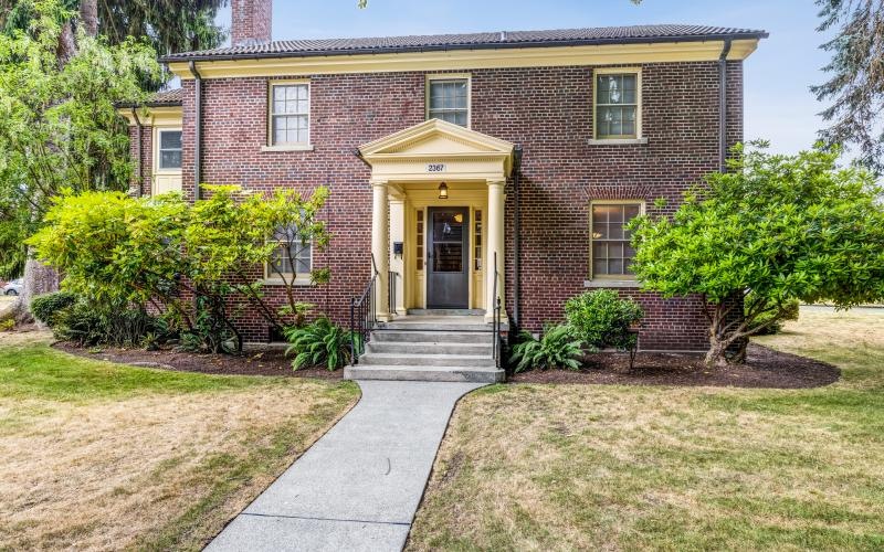 a brick house with a front yard