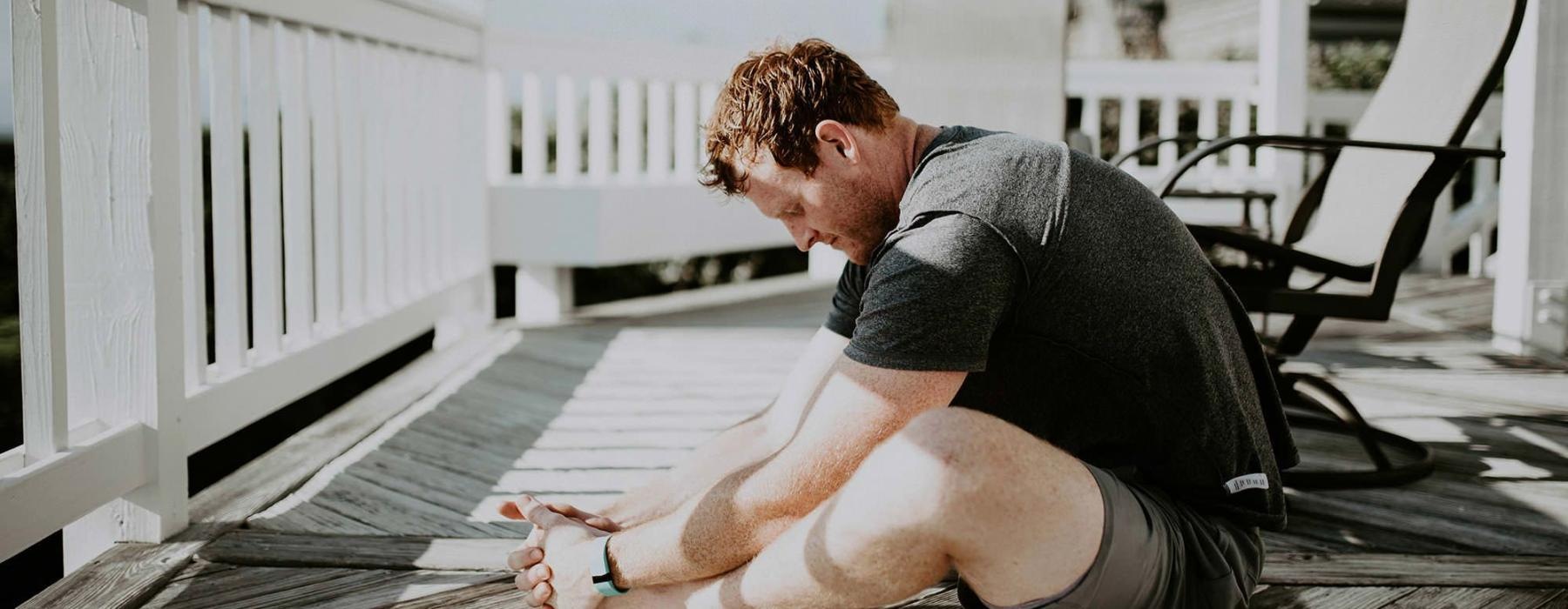man stretching on a deck