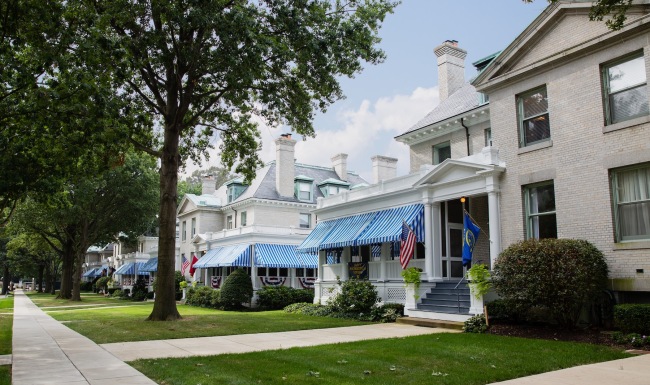 a row of houses with front yards and trees