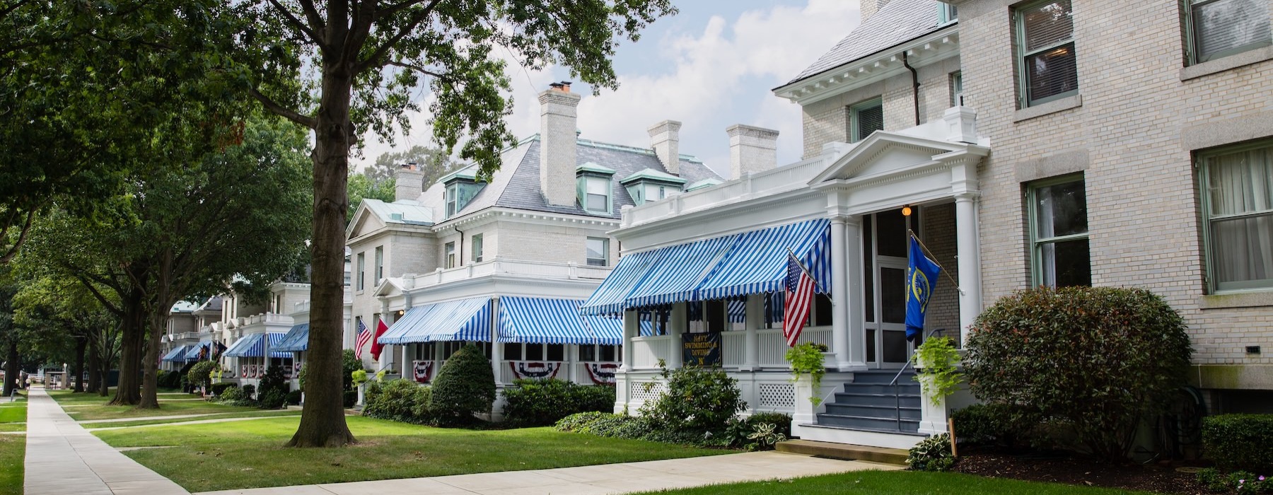 a row of houses with front yards and trees