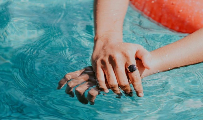 woman relaxes on a floatie in swimming pool