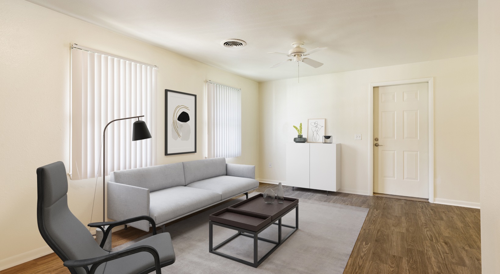 living room with couch, chair, coffee table with rug.