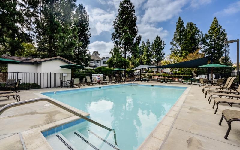 a swimming pool with chairs around it