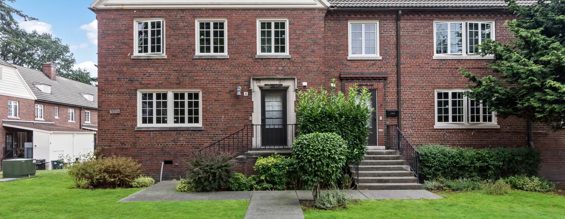 a brick house with a front yard