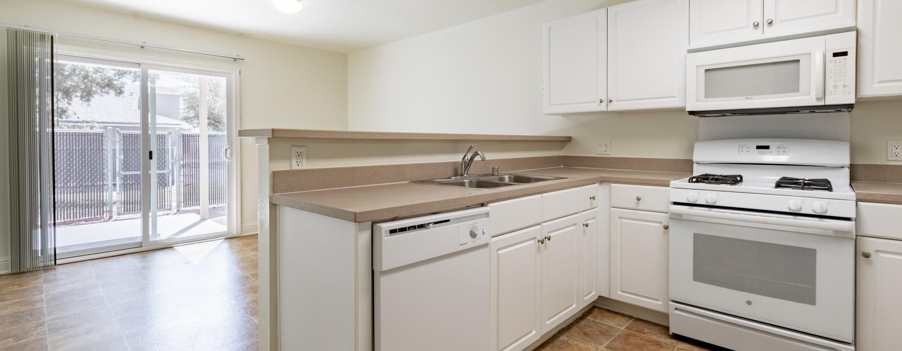 a kitchen with white cabinets