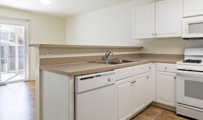a kitchen with white cabinets