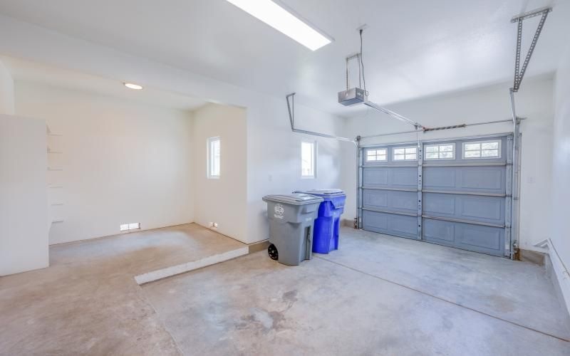 a room with a trash can and a door