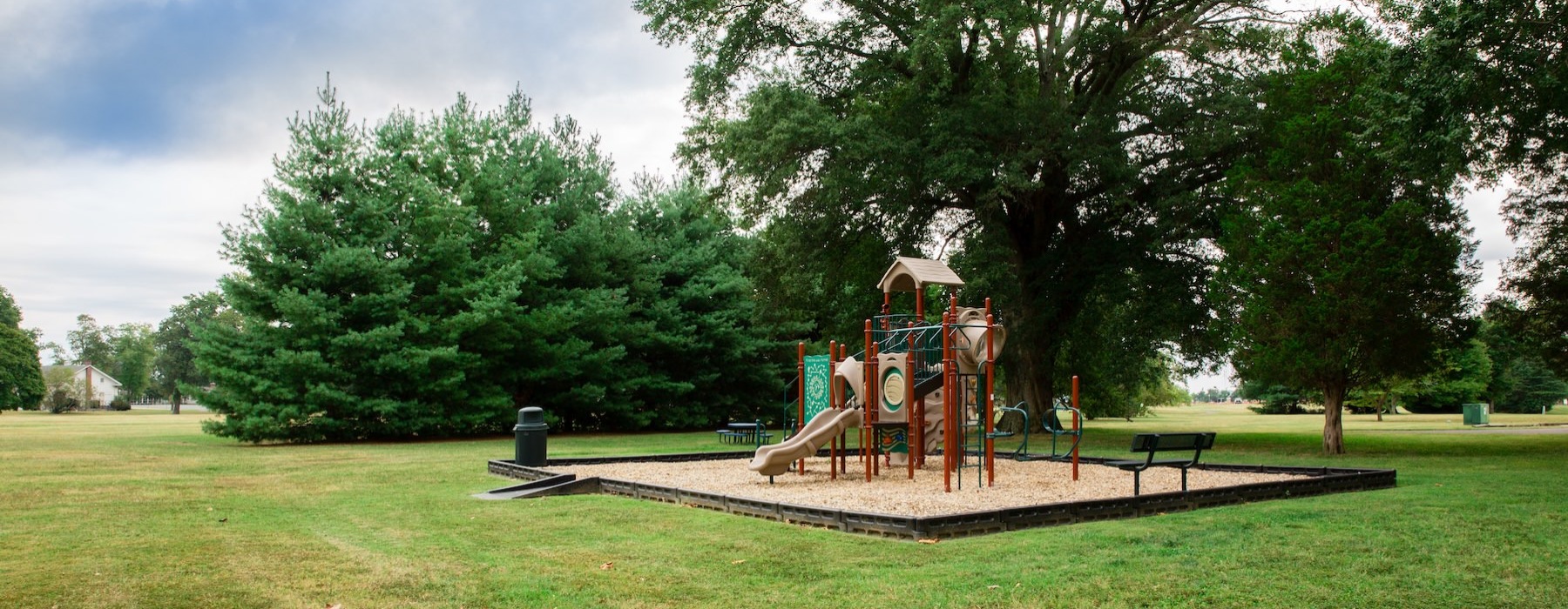 a playground with a slide in a park
