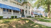 a house with a front yard and a flag hanging on the front porch