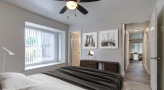 a bedroom with a bed and a fan