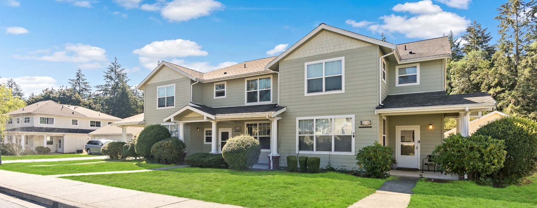 a home with a sidewalk and grass in front