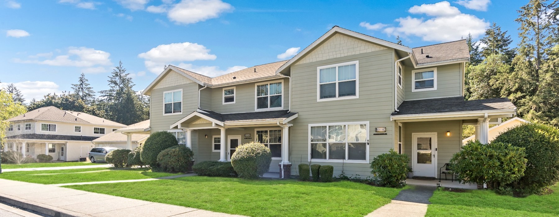 a home with a sidewalk and grass in front