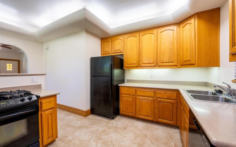 a kitchen with wooden cabinets