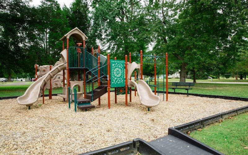 a playground with trees and grass