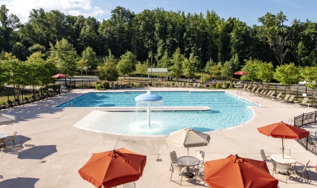 a pool with umbrellas and chairs next to it
