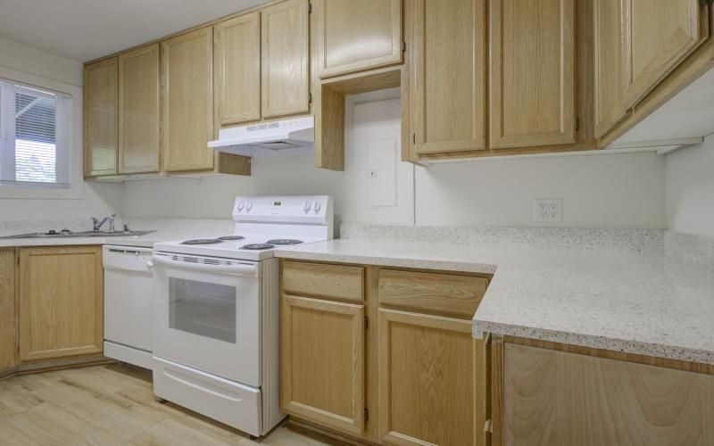 a kitchen with wooden cabinets