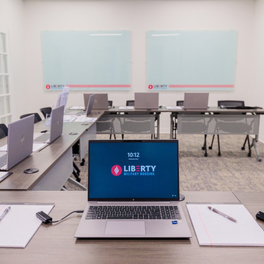 Classroom training room set up with laptops on individual desks.