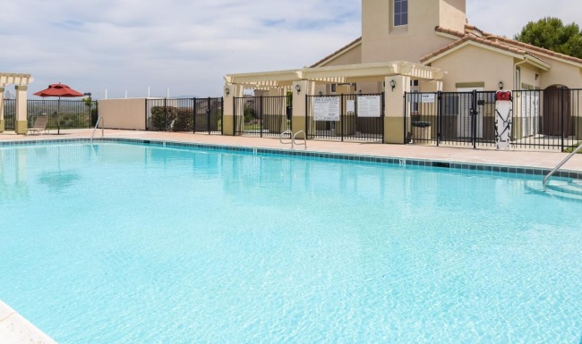 a swimming pool in front of a building
