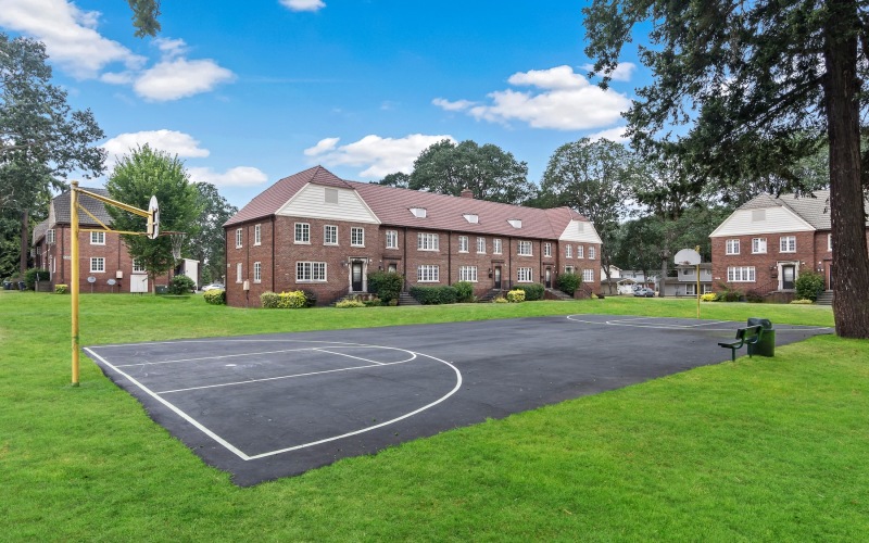 a basketball court with a building behind it