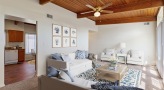 a room with a ceiling fan and a wood floor