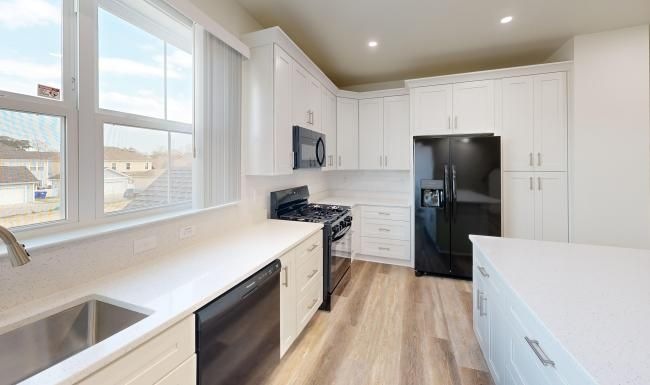 a kitchen with white cabinets
