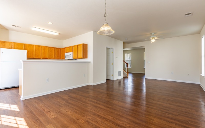 living room with wood floors and kitchen