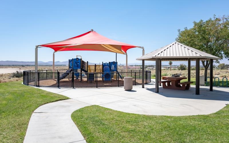 a gazebo with a table and chairs on a patio