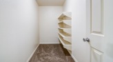 a white room with a white door and shelving