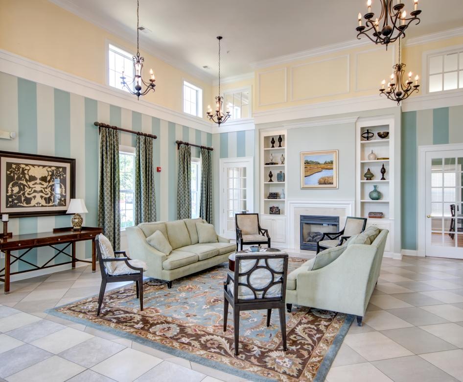 a club room with a chandelier and a couch