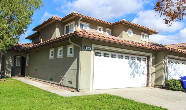 a house with a garage and a lawn in front of it