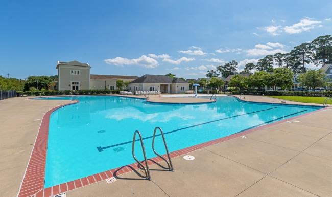 Resort-style swimming pool with lounge seating