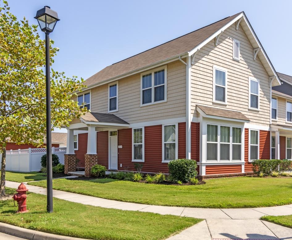 a large house with a red fire hydrant in front of it