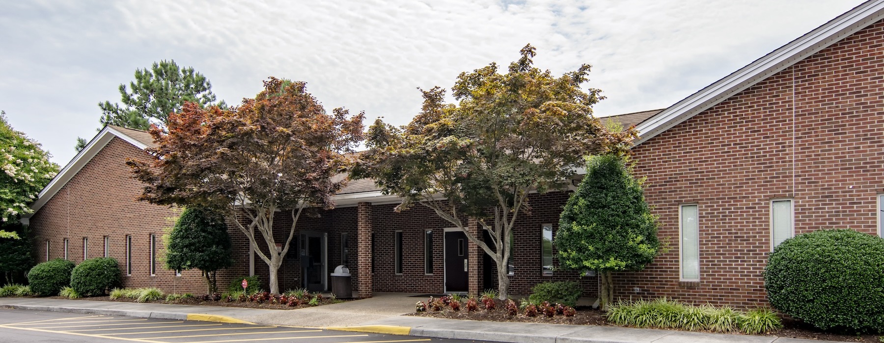 a large brick building with trees