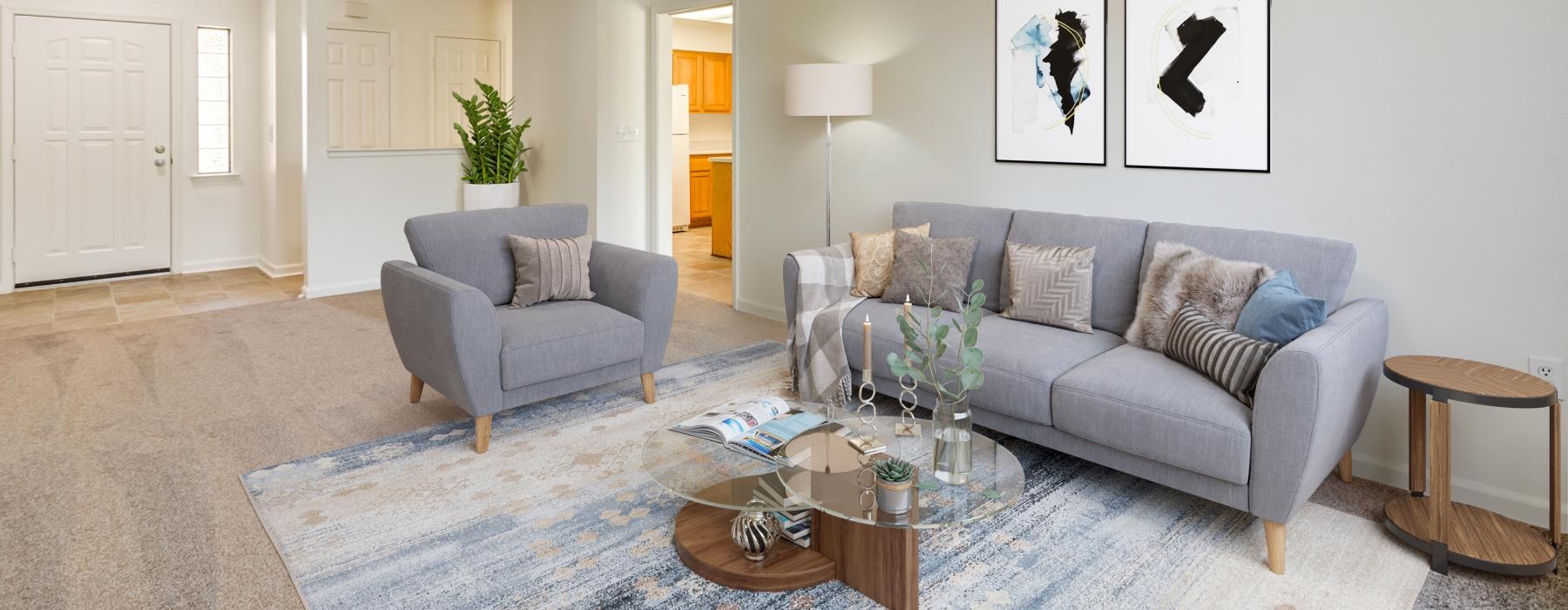 a living room with a couch and a fan