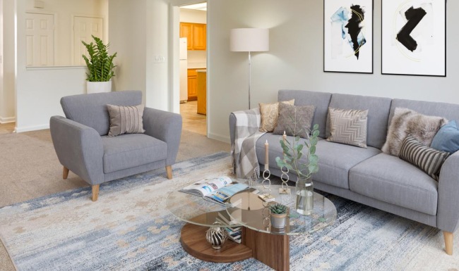 a living room with a couch and a fan