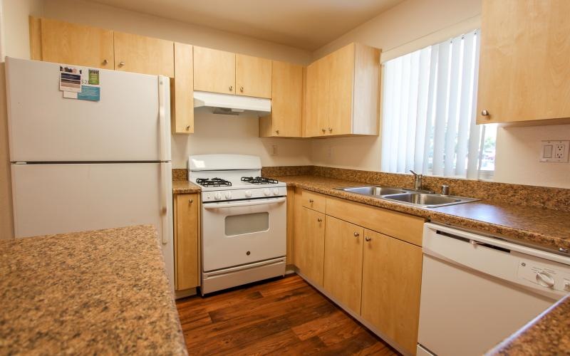 a kitchen with wooden cabinets