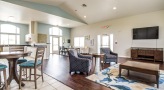 a large room with a bar and chairs
