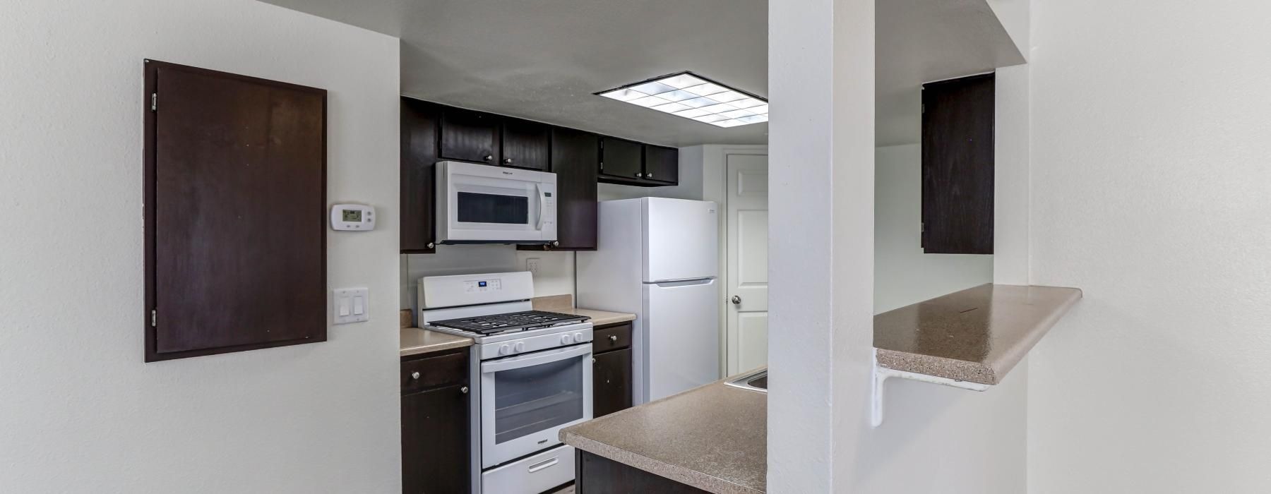 a kitchen with a microwave oven and refrigerator
