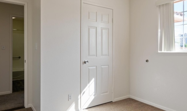 natural lighting floods bedroom through large windows