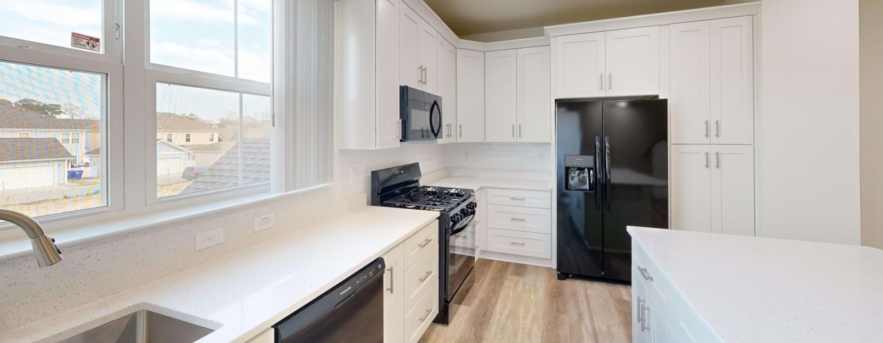 kitchen with white cabinets and black appliances
