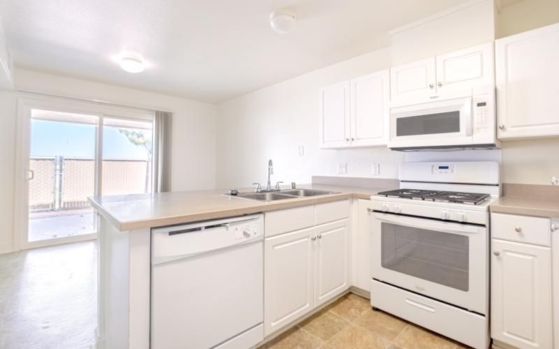 a kitchen with white cabinets