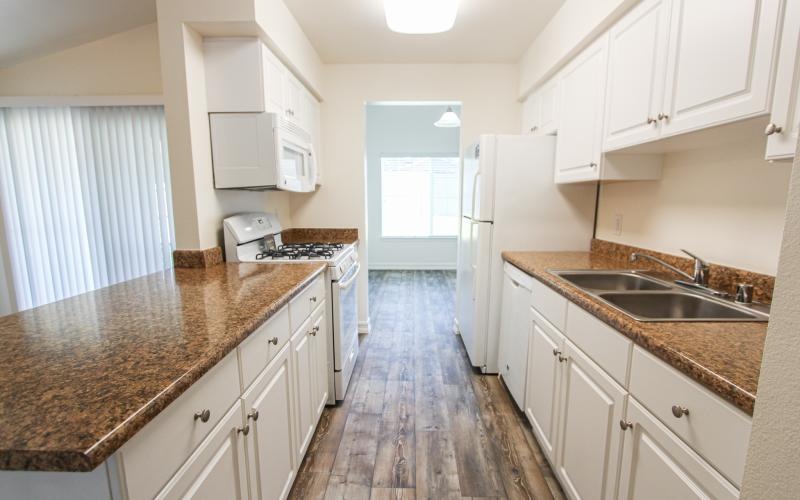 a kitchen with white cabinets