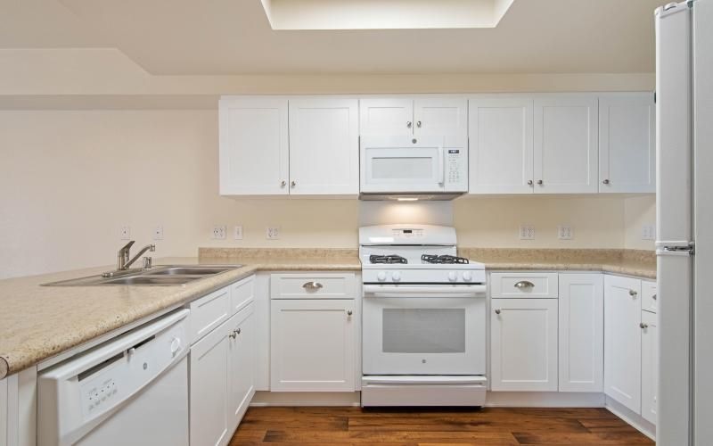 a kitchen with white cabinets