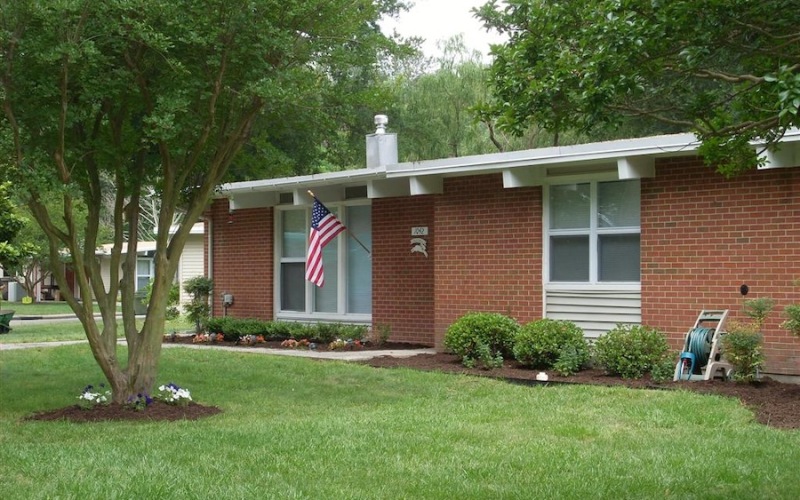 the exterior of a home with a flag