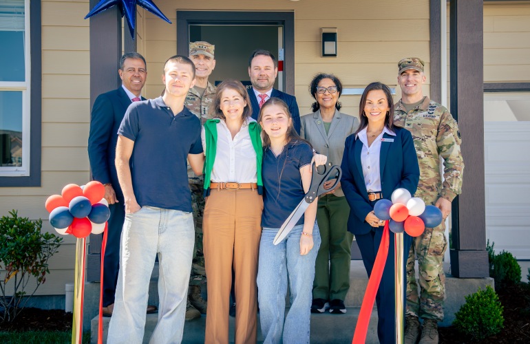 picture of ribbon cutting for Meriwether Landing, including the family, Beth Peterson Regional Vice President, West Army Region - Liberty Military Housing, Philip Rizzo, CEO, Liberty Military Housing , Mr. Adam Dontz, Deputy Assistant Secretary of War for